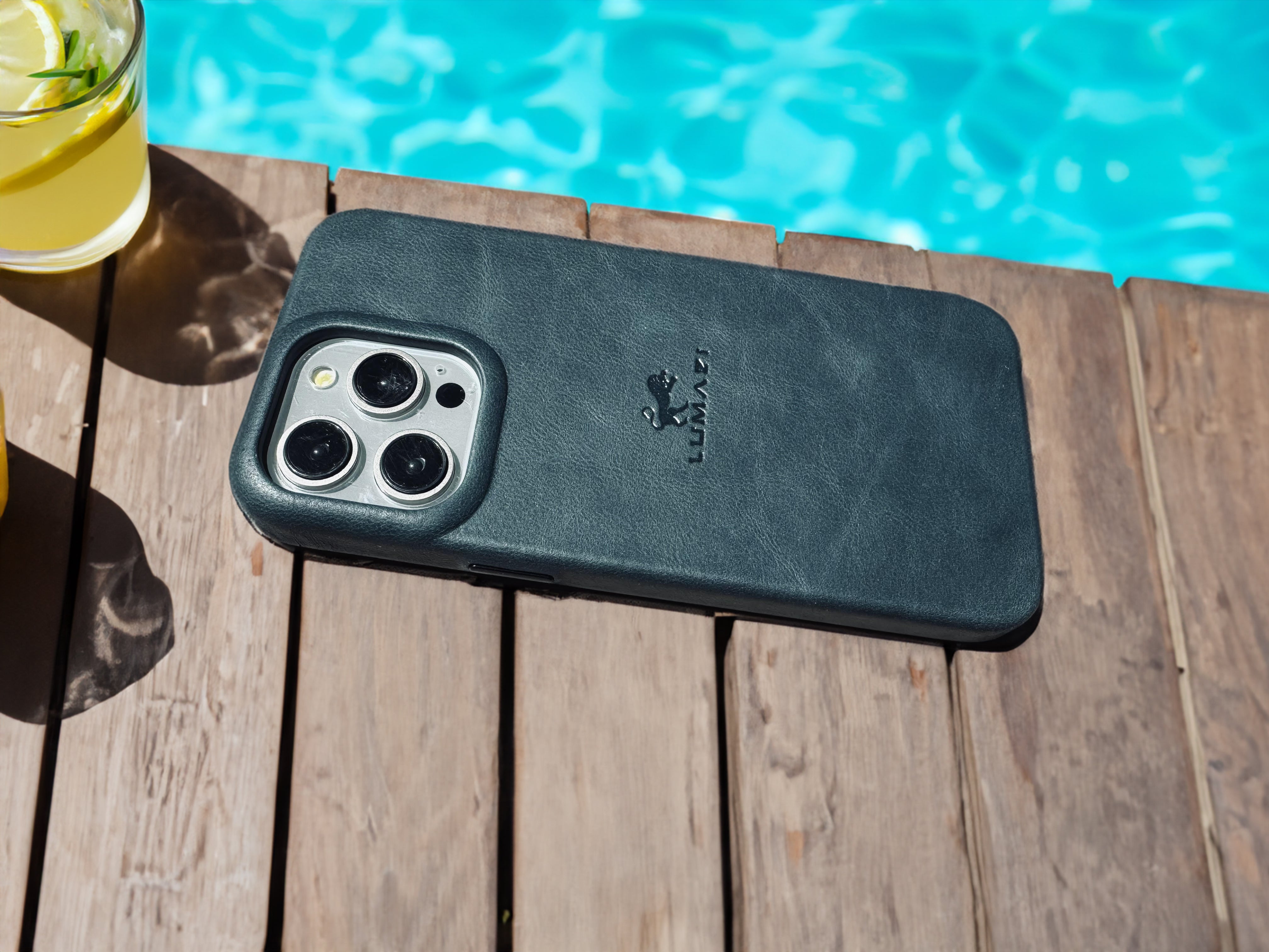 LUMAZI Mediterranean Sea teal turquoise blue green, full-grain leather iPhone 15 Pro Max case bottom.